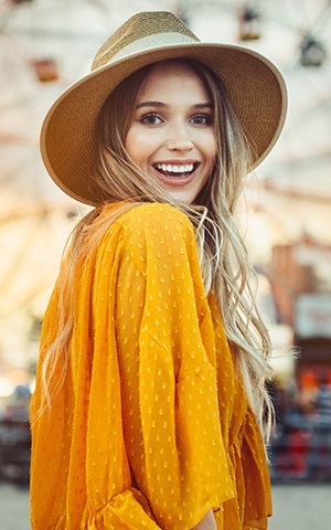 woman in yellow smiling