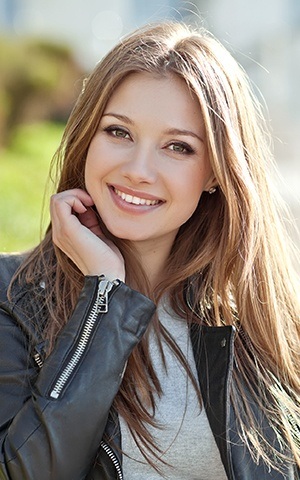 model smiling in moto jacket