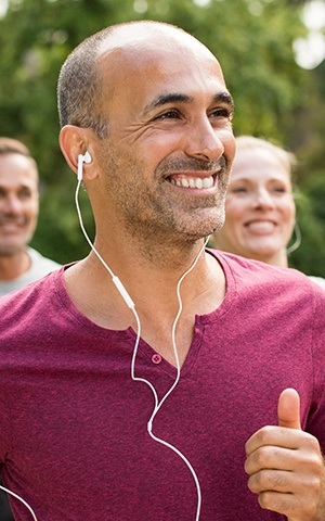 man running with headphones in