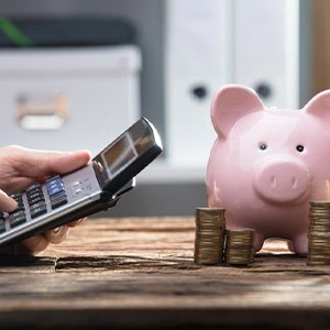 Calculator is used near piggy bank