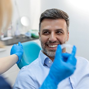 A man receiving an Invisalign aligner from his dentist