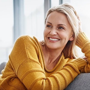 a woman smiling after undergoing All on 4