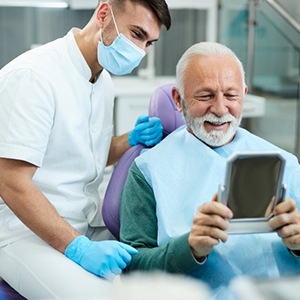 a patient checking his teeth after receiving All on 4