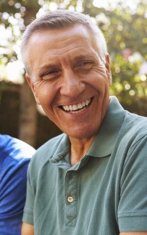 man in green shirt smiling