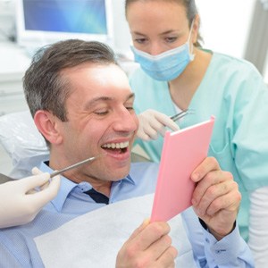 man smiling after getting dental bridge in Costa Mesa