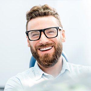 man with glasses smiling