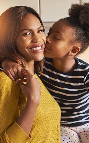 daughter kissing mother's cheek