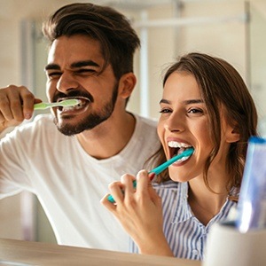 couple brushing teeth