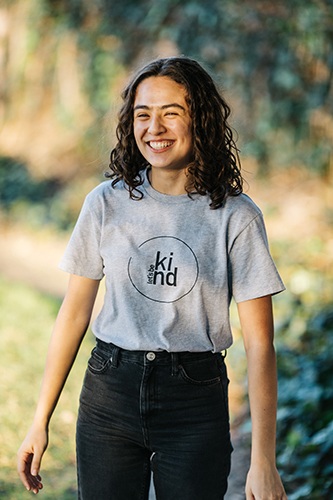 child with Lets Be Kind shirt on