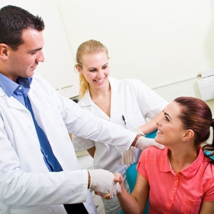 woman shaking dentist's hand