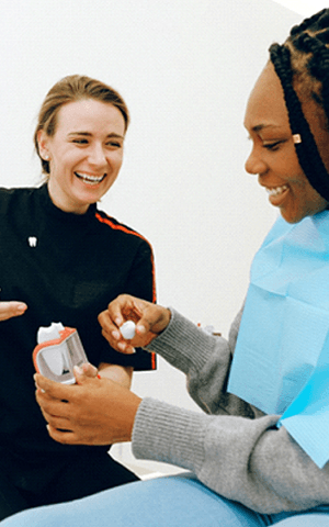 Woman speaking with dentist about dental crowns