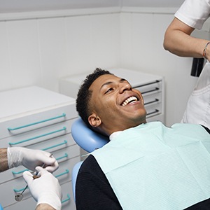 Patient smiling while relaxing in treatment chair
