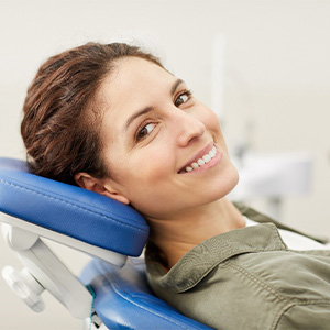 A smiling woman happy with her new tooth-colored filling