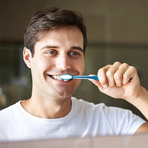 man brushing teeth