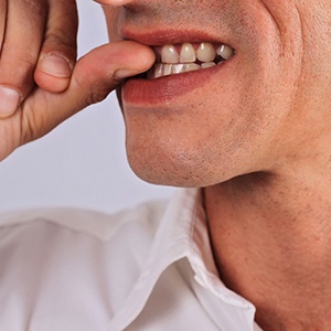 Close-up of a man biting his fingernails
