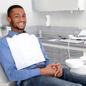 smiling man sitting in dental chair