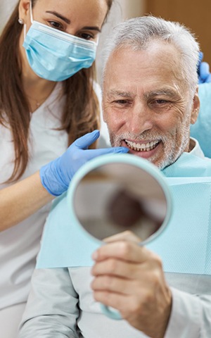 Happy patient after successful dental implant salvage in Costa Mesa