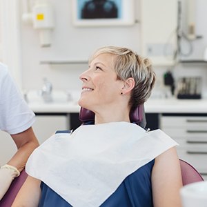 Middle-aged woman talking to dentist