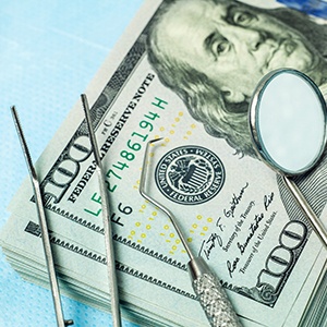 Dental tools lying on pile of money