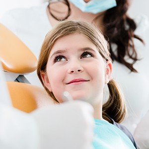 young girl looking up at dentists