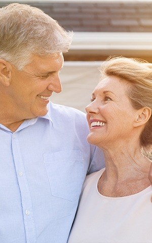 husband and wife smiling at each other