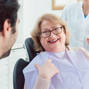 elderly woman with glasses smiling