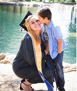 graduating mother with son by water