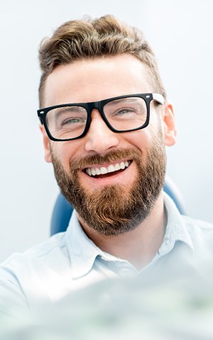 Man with an attractive smile after full mouth reconstruction.