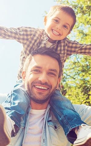 son on father's shoulders