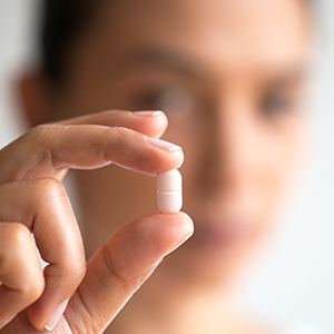woman holding sedation pill