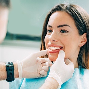 dentist checking woman's teeth