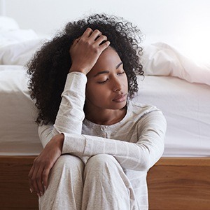 woman sitting on floor sad