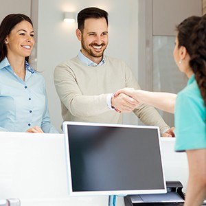 man shaking assistants hand