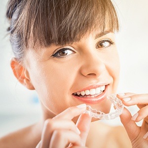 woman putting in invisalign