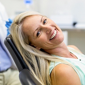 woman in light blue smiling