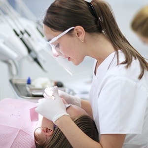 assistant working on patient