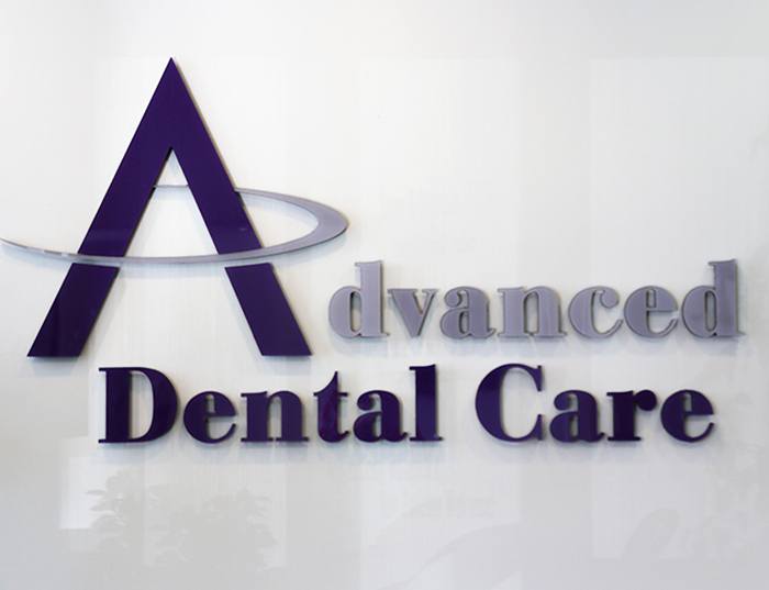 closeup of advanced dental care logo on wall