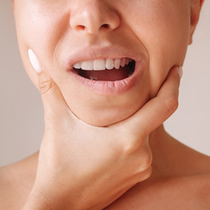 Closeup of patient experiencing jaw pain