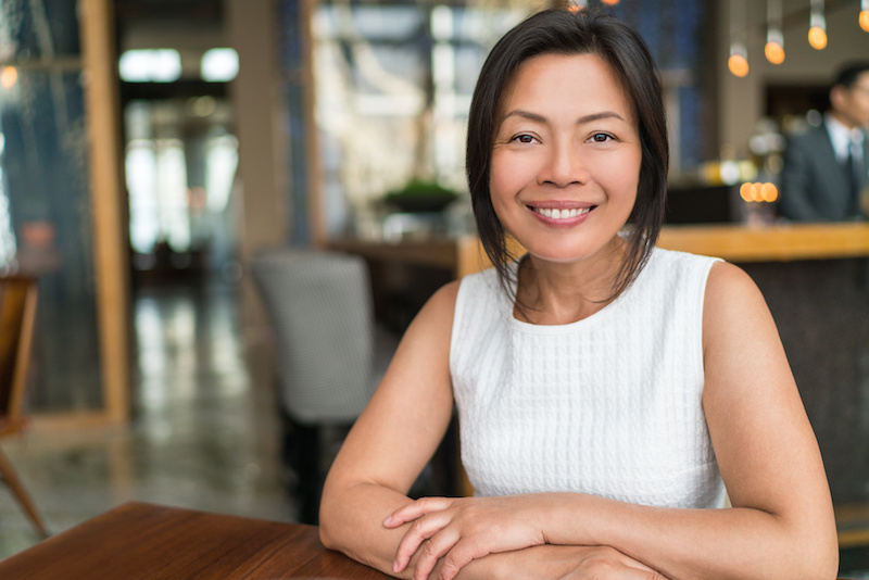 Happy elegant Asian middleaged businesswoman smiling portrait
