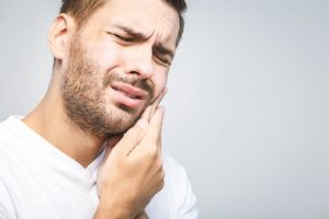 Man in need of an emergency dentist in Costa Mesa