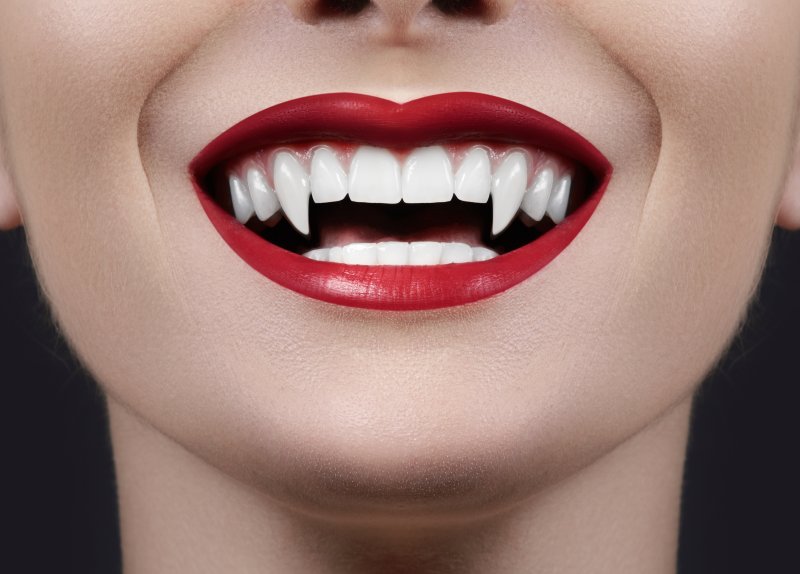 girl smiling with vampire fangs from tiktok trend