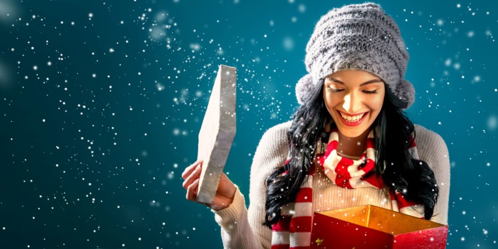 person smiling at a present that they're opening