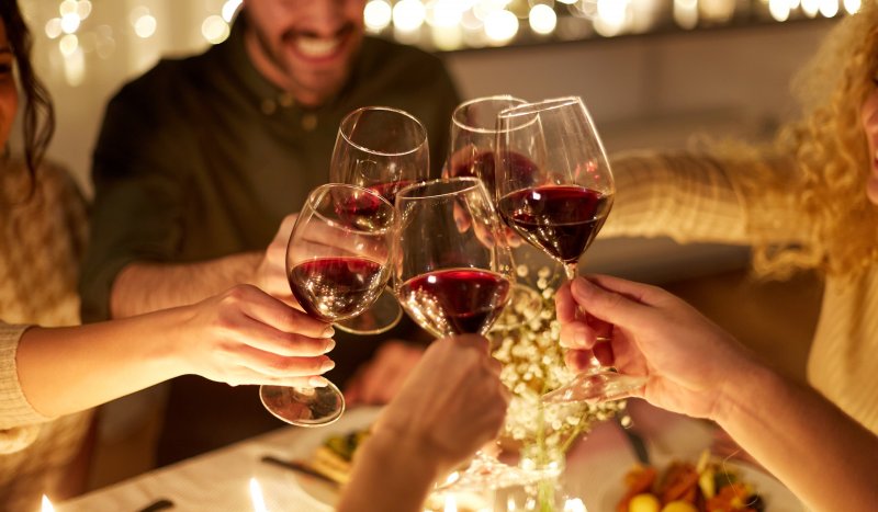 Patient enjoying wine at holiday party after teeth whitening