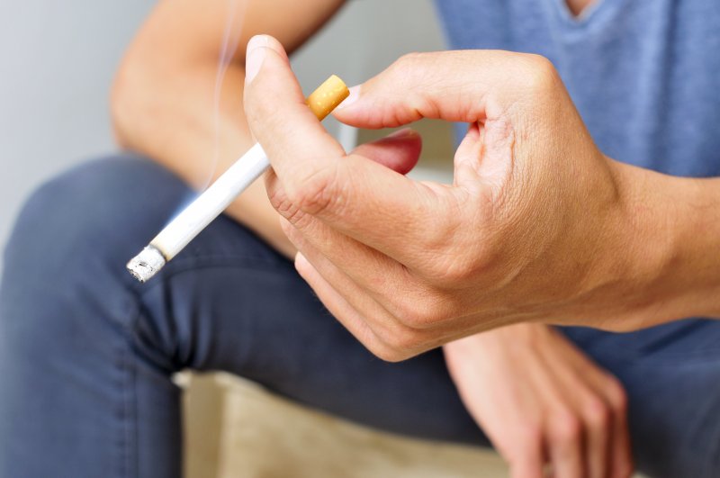 Closeup of man holding a cigarette