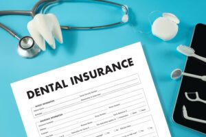 Dental insurance document next to dental instruments