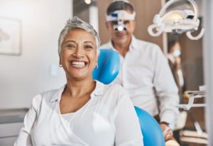 Happy dental patient smiling in treatment chair