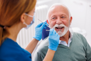 a patient smiling while visiting their dentist 