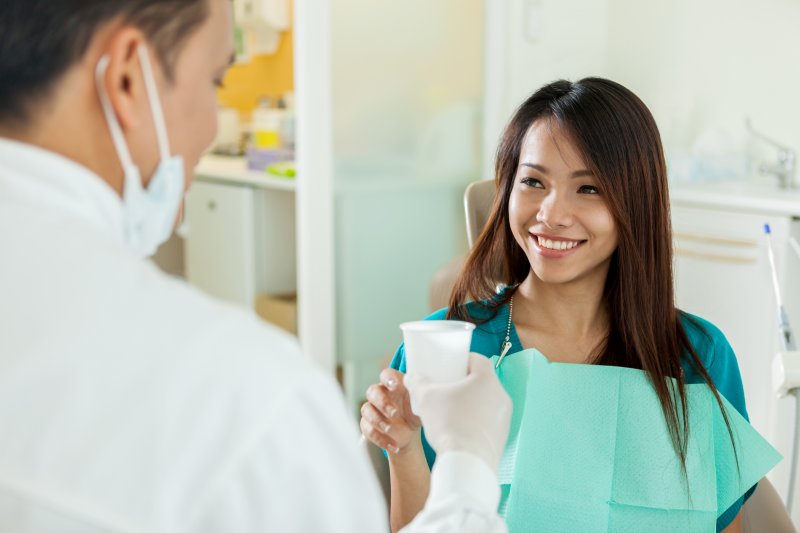 woman comfortable with visiting her dentist in Costa Mesa