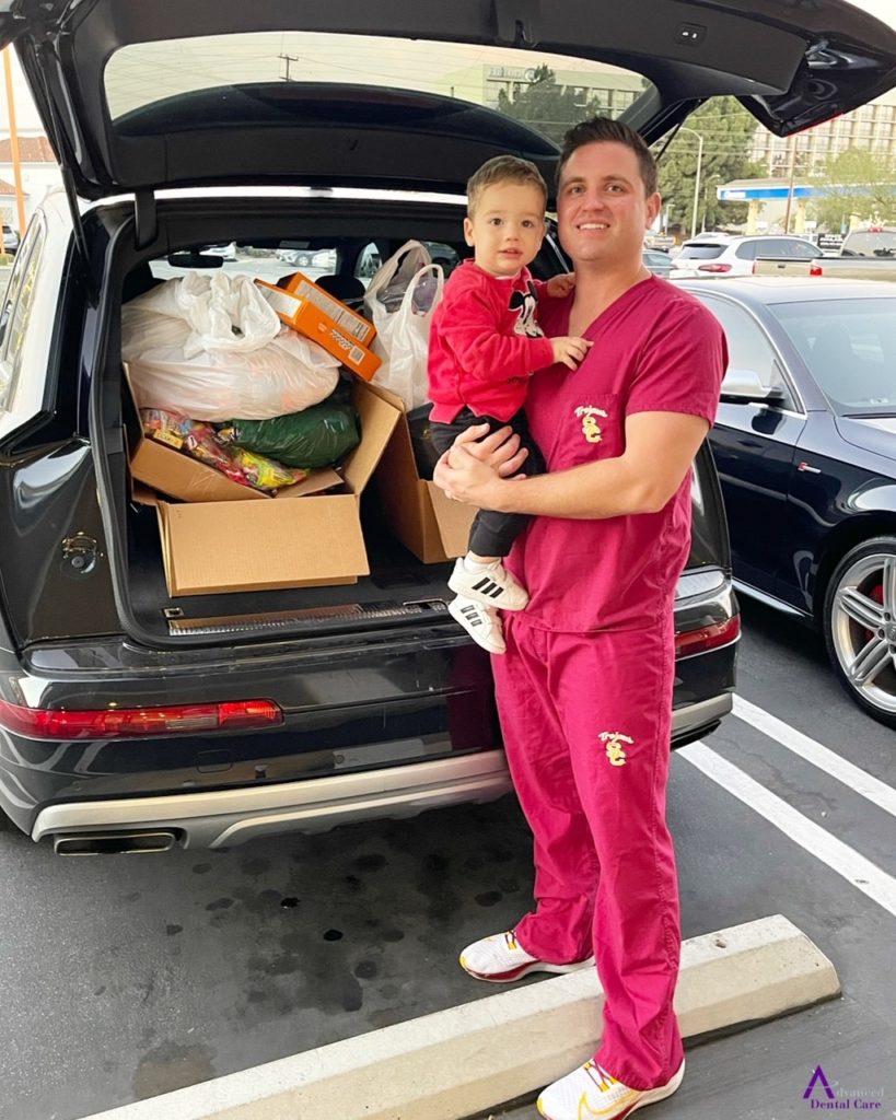 Dr. Jeremy Jorgenson and son Julian packing up Halloween candy for Operation Gratitude