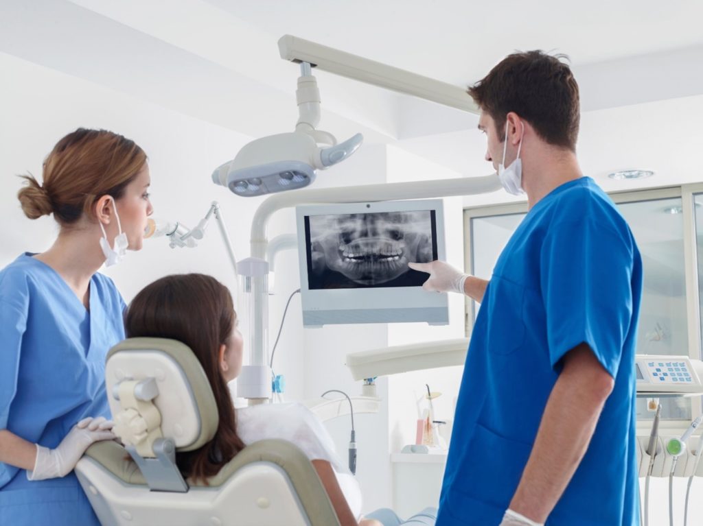 Patient at the dentist’s office viewing their dental x-rays.